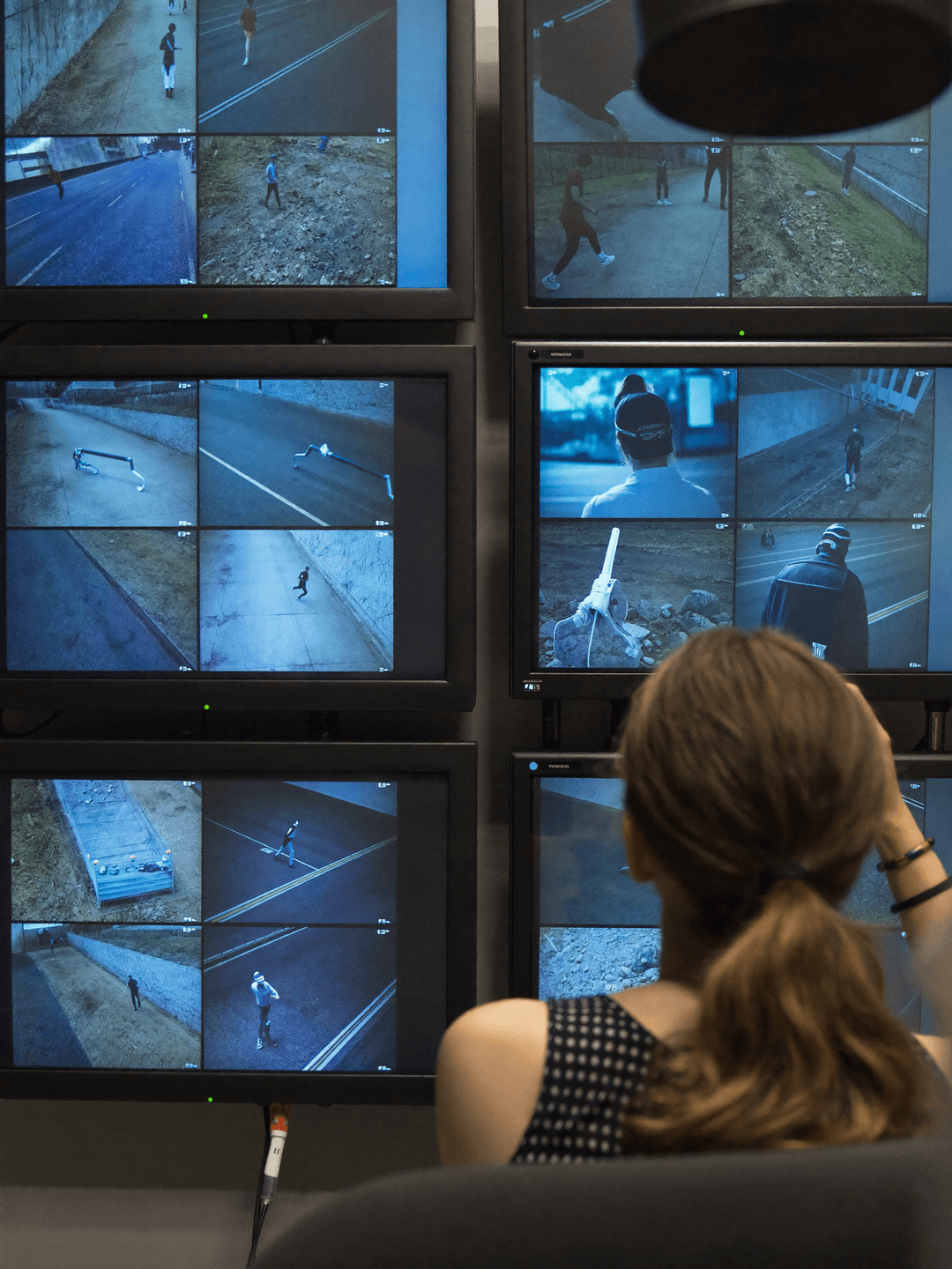 A CCTV operator watching a wall of monitors